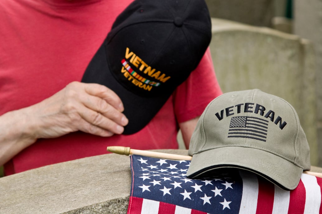 Vietnam Veteran hat over heart saluting fallen solider